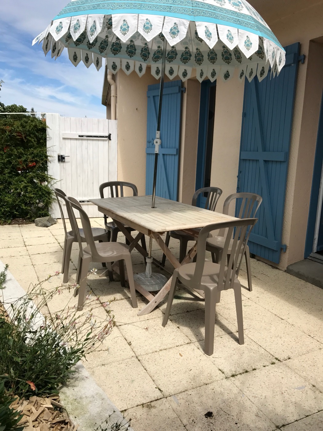B26's sun-trap terrace with table and parasol