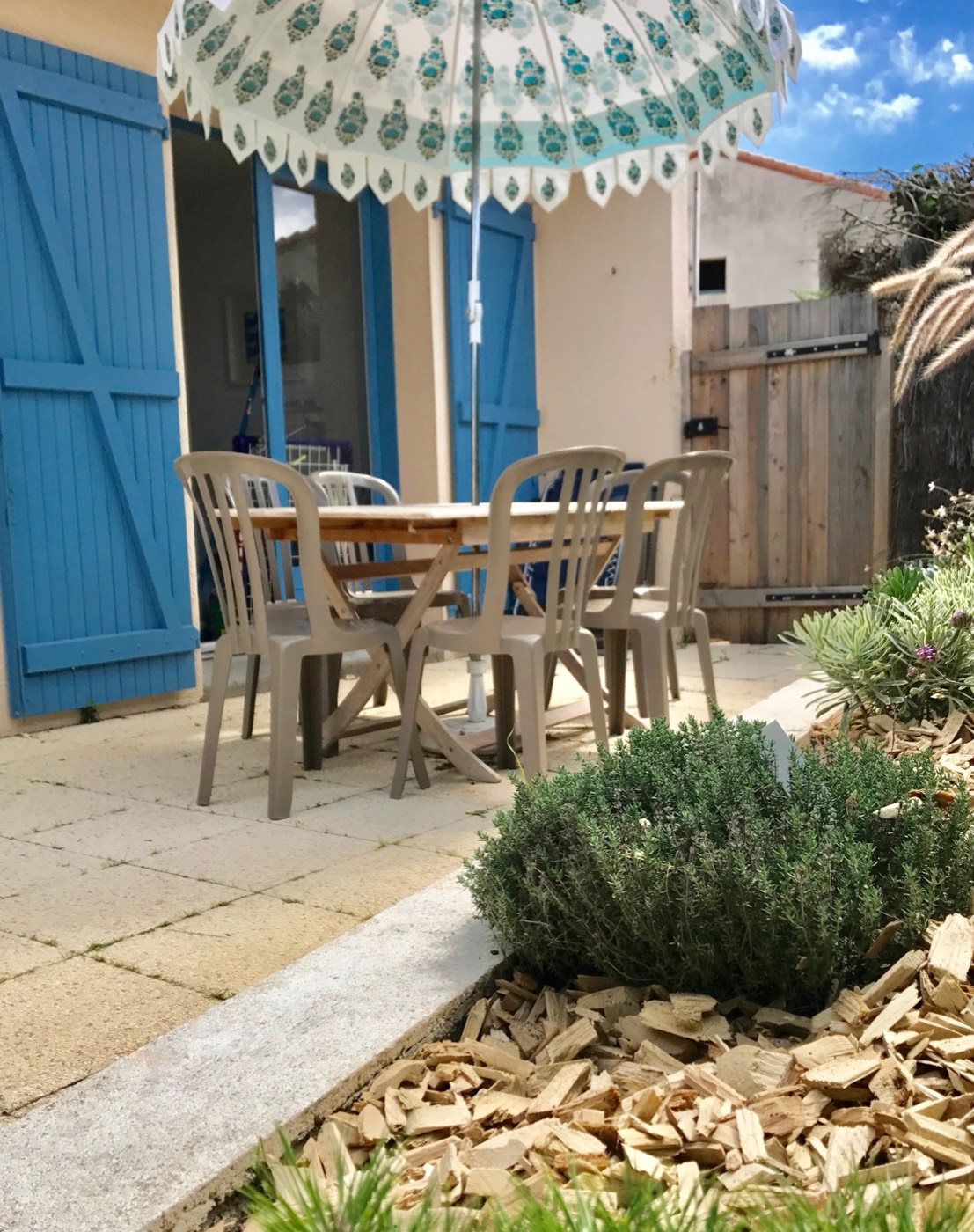B26's sun-trap terraced garden with a table and chairs