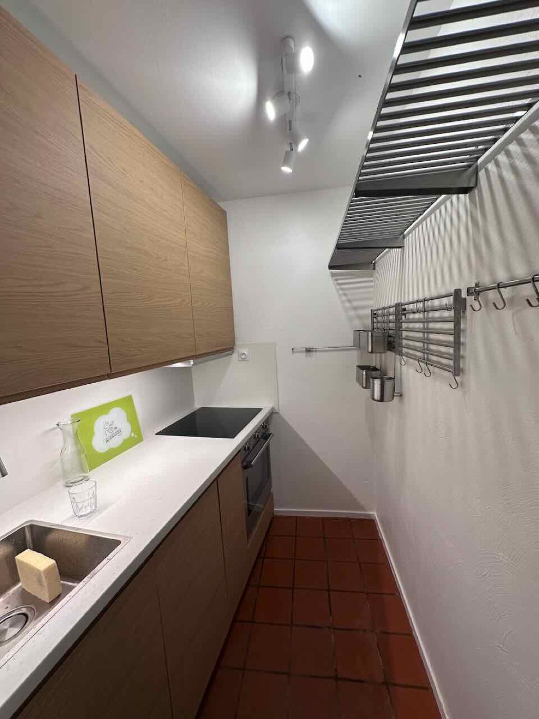 B26's recently renovated galley kitchen with oven, induction hob and dishwasher