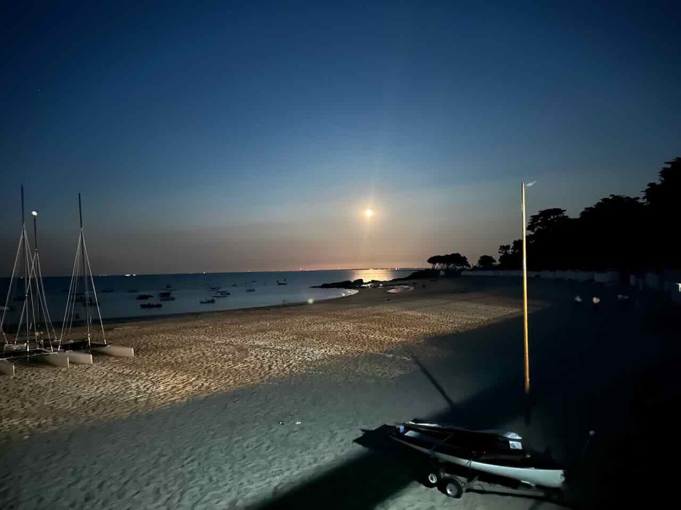 Moonlight over Plages des Dames at night, dinghies on the sand